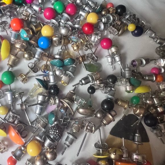 Bag full of different colored stud earrings. - Picture 12 of 13